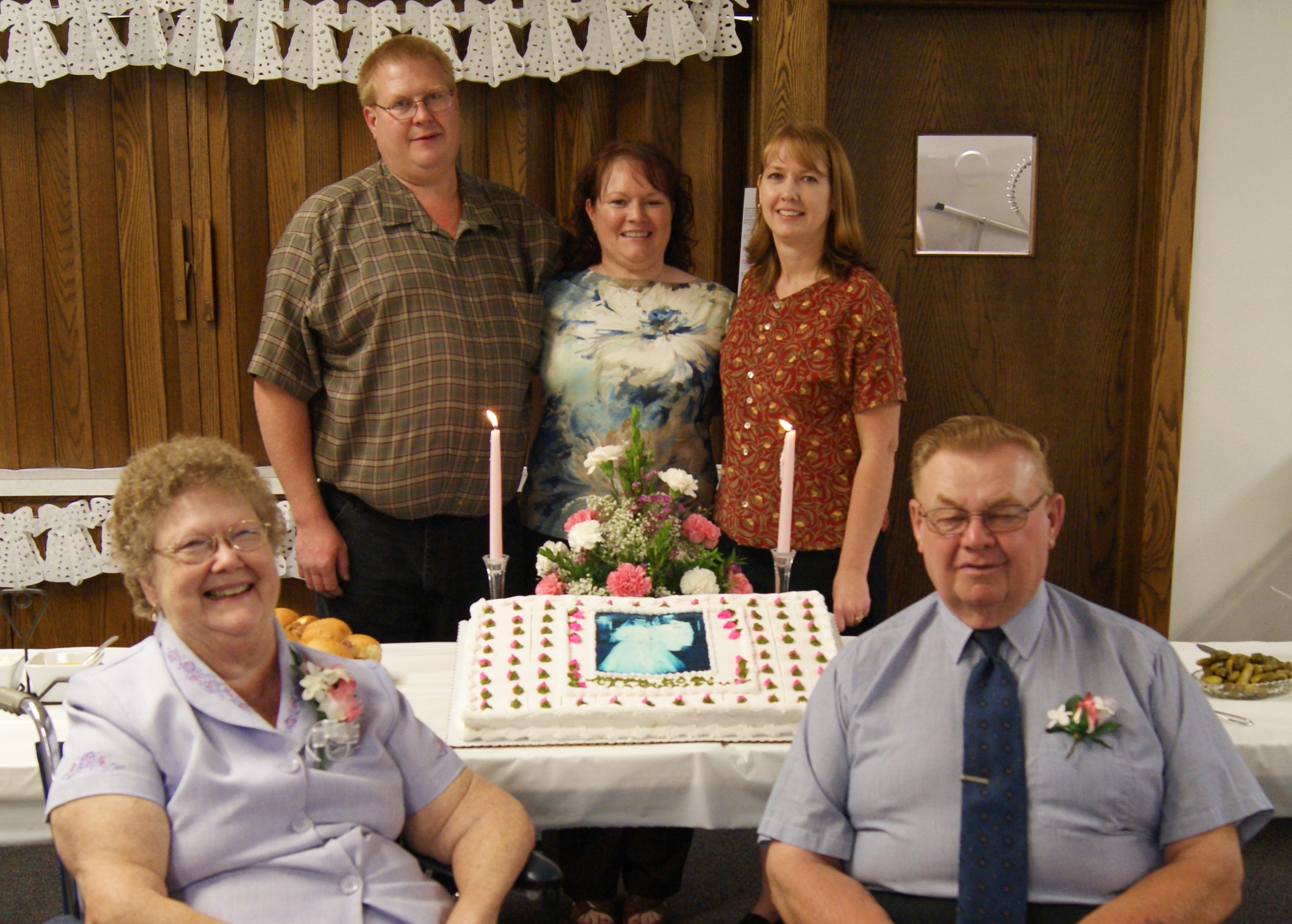 Gracie celebrating with her family around a decorated cake